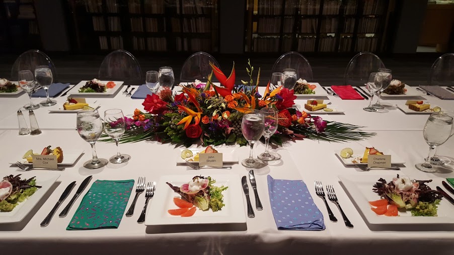 Sit down dinner table set up with floral arrangement in the middle