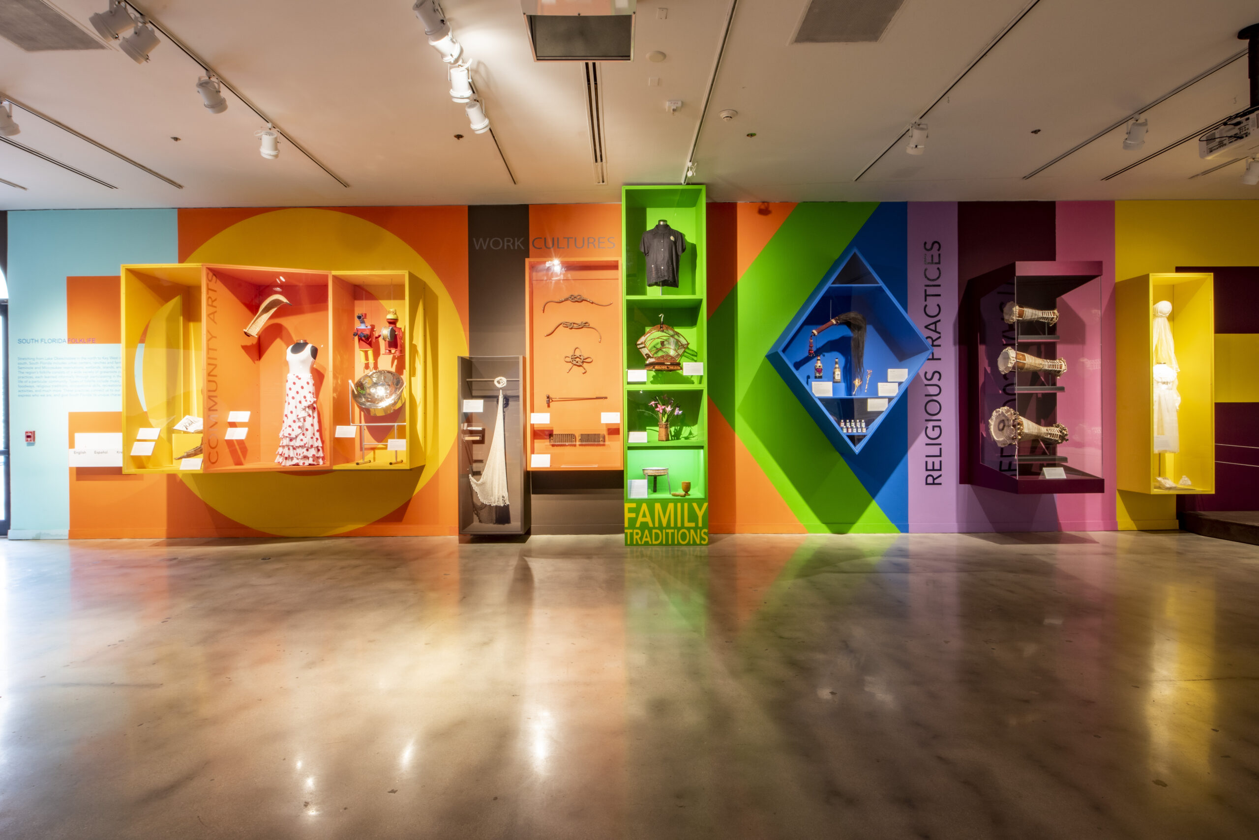 Folklife Gallery featuring artifacts in colorful cases.