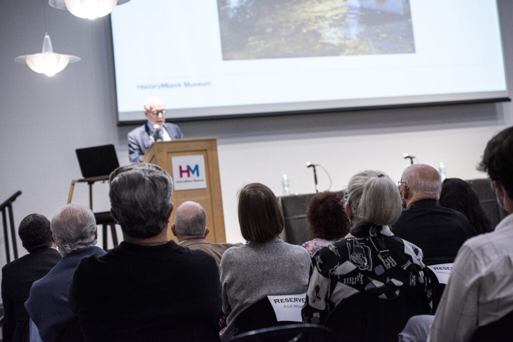 Adults seating in auditorium paying attention to a presentation