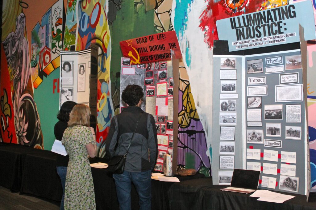 two people looking at history fair project