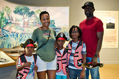 Two adults and three children posing for a picture