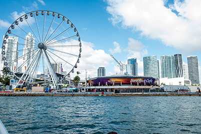 Bayside skyline looking from the water. Tall buildings on the right, Hard Rock Cafe restaurant in the middle, and ferris wheel on the left