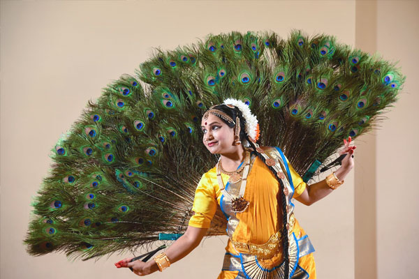 woman with peacock feathers