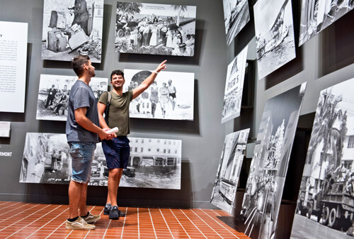boys pointing at old photos